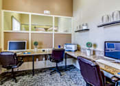 Thumbnail 20 of 41 - A home office with a desk, chairs, and computer monitors.