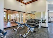 Thumbnail 9 of 41 - A gym with a row of dumbbells and a sign that says "Results = Excuses".