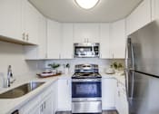 Thumbnail 1 of 28 - a kitchen with white cabinets and stainless steel appliances