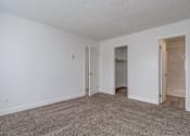 Thumbnail 12 of 28 - a bedroom with white walls and carpet