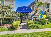 Thumbnail 9 of 24 - A blue canopy with the word "Sunshine" written on it is above a gate.
