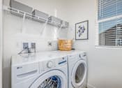 Thumbnail 20 of 27 - A white LG washing machine and dryer in a laundry room.