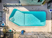 Thumbnail 4 of 18 - A rectangular pool with a blue tiled border.