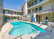 Thumbnail 3 of 18 - A swimming pool is located on the balcony of a building.