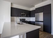 Thumbnail 23 of 27 - Kitchen Bar With Granite Counter Top at Citron Apartment Homes, Riverside, CA
