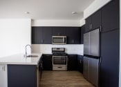 Thumbnail 19 of 27 - Fully Equipped Kitchen at Citron Apartment Homes, Riverside, CA, 92506