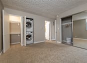 Thumbnail 6 of 34 - A laundry room with a washer and dryer.