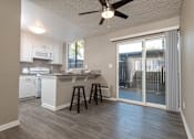 Thumbnail 4 of 34 - A kitchen with white cabinets and a bar stool.