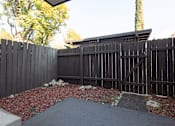 Thumbnail 22 of 34 - A black fence with a gate and a small garden in front.