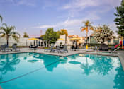 Thumbnail 1 of 34 - A large swimming pool with a reflection of the surrounding trees.