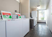 Thumbnail 20 of 34 - A row of white Wash UT appliances are lined up in a room.