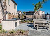 Thumbnail 11 of 33 - A concrete bench is in front of a black fence.