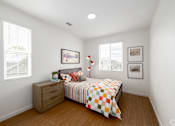 Thumbnail 22 of 33 - A bedroom with a bed, dresser, and two pictures on the wall.
