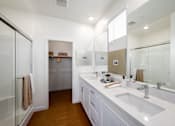 Thumbnail 18 of 33 - A bathroom with a white sink and a mirror.