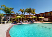 Thumbnail 5 of 24 - Swimming Pool and Spa at Huntington Cove Apartment Homes in Huntington Beach, California.