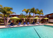 Thumbnail 4 of 24 - Swimming Pool and Spa at Huntington Cove Apartment Homes in Huntington Beach, California.