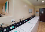 Thumbnail 9 of 24 - Laundry Care Centers at Huntington Cove Apartment Homes in Huntington Beach, California.