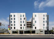 Thumbnail 11 of 29 - A modern building with a white facade and black accents.