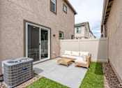 Thumbnail 8 of 33 - A patio with a couch, chairs, and an air conditioning unit.