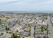 Thumbnail 6 of 13 - A view of a residential area with houses and roads.