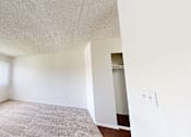 Thumbnail 23 of 25 - A room with a window covered by white blinds and a carpet on the floor.