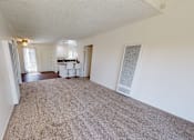 Thumbnail 25 of 25 - A room with a carpeted floor and a white wall.