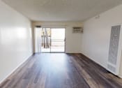Thumbnail 17 of 25 - A room with a sliding glass door leading to a balcony.