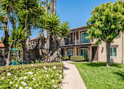 Thumbnail 5 of 25 - A building with a green lawn in front.