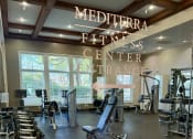 Thumbnail 17 of 41 - A gym with a variety of equipment including dumbbells and weight machines.