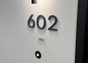 Thumbnail 24 of 29 - A white door with a black handle and a number 602 on it.