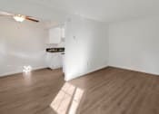 Thumbnail 7 of 23 - Open-concept living area with white walls and natural light in Tustin apartment
