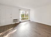 Thumbnail 5 of 23 - Living room with wood floors and big windows.