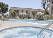 Thumbnail 8 of 14 - a swimming pool with a building in the background
