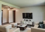 Thumbnail 7 of 14 - a living room with white couches and a tv on the wall
