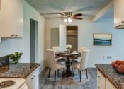 Thumbnail 3 of 14 - a kitchen and dining room with a table and chairs