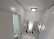 Thumbnail 15 of 24 - a bathroom with a sink toilet and mirror