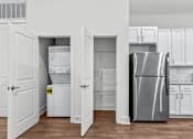 Thumbnail 20 of 38 - A kitchen with white appliances and cabinets. at The Quarter Lofts Apartments, Mississippi