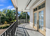 Thumbnail 4 of 38 - A balcony with a black railing and a patterned floor. at The Quarter Lofts Apartments, Jackson, Mississippi