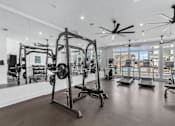 Thumbnail 10 of 38 - A gym with a variety of equipment including treadmills, weights, and exercise machines. at The Quarter Lofts Apartments, Jackson, 39216
