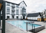 Thumbnail 19 of 22 - large white building with a pool at Eastover Commons Residential, Mississippi