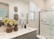 Thumbnail 34 of 35 - Bathrooms with dual sinks, wood plank floors, walk-in showers  at Pillar at Fountain Hills