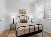 Thumbnail 23 of 31 - a bedroom with a bed and a large window at Village of Chandler Apartments, Chandler, AZ