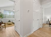 Thumbnail 20 of 31 - an open living room and dining room with white walls and wood floors at Village of Chandler Apartments, Arizona