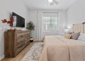 Thumbnail 16 of 31 - a bedroom with a bed and a tv at Village of Chandler Apartments, Chandler, AZ, 85249