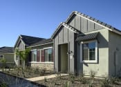 Thumbnail 1 of 31 - the front of a house with a driveway and a sidewalk at Village of Chandler Apartments, Chandler, 85249