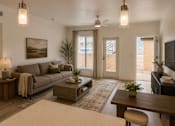 Thumbnail 9 of 10 - A living room with a grey couch, a wooden coffee table, and a painting on the wall.