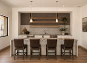 Thumbnail 6 of 10 - A kitchen with a white countertop and brown chairs.