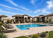Thumbnail 4 of 10 - A large house with a pool in the backyard.
