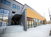 Thumbnail 14 of 19 - A modern building with a combination of grey and yellow panels.