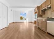Thumbnail 7 of 10 - a kitchen with wooden floors and a window